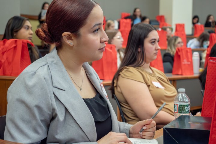 students listen as a speaker talks in a classroom