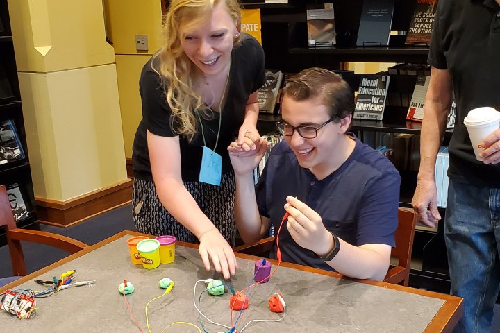 two students use technology in a workshop