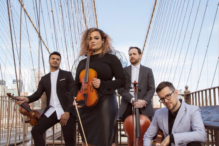 members of PubliQuartet pose on suspension bridge