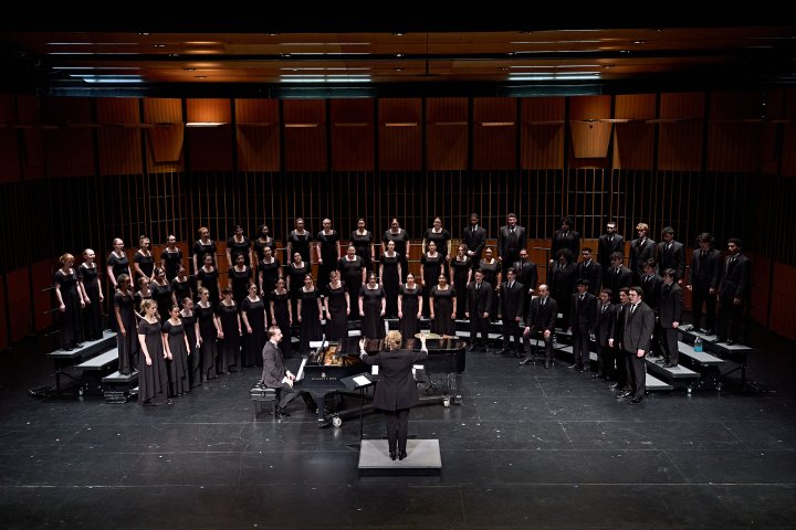 Choir on stage with director