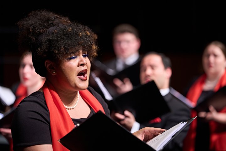 Choral performer on stage with choir