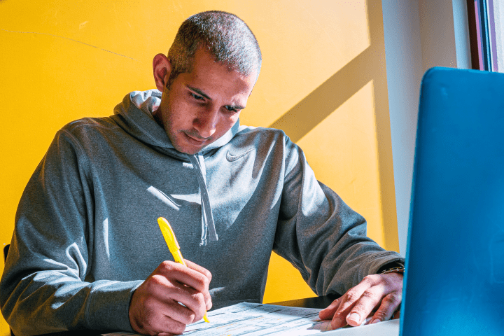 Student writes in a notebook.