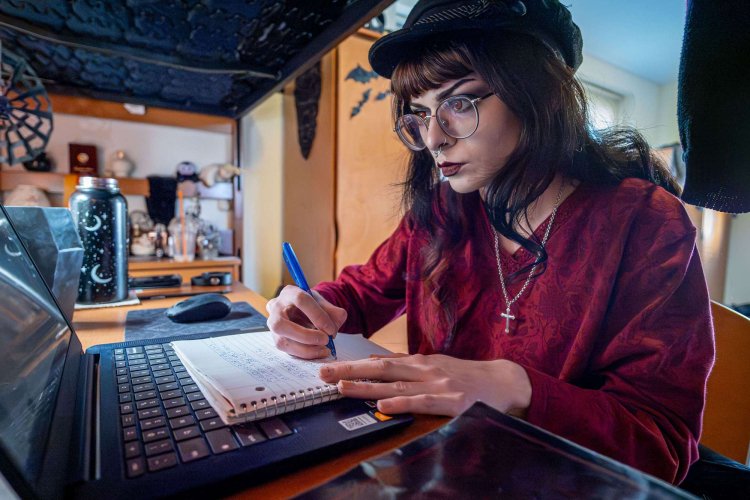Katie Cicero sits at a desk doing homework.