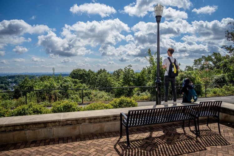 Students on campus looking at the NYC skyline.
