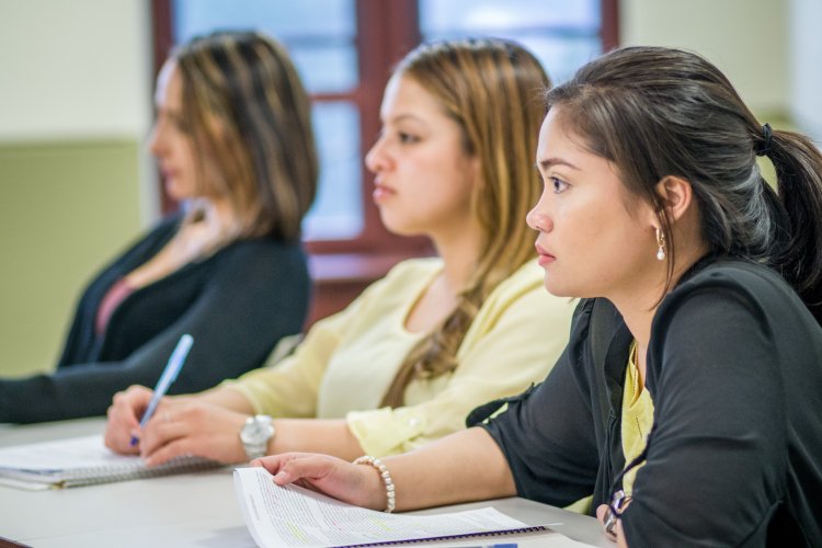 Students in a classroom taking notes
