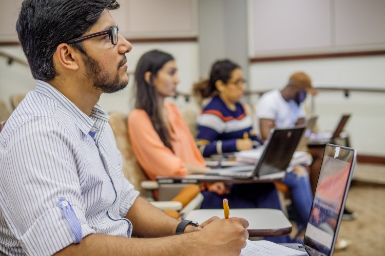 Students in class taking notes