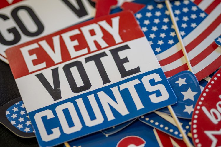 Every Vote Counts sticker on a table with other voting stickers