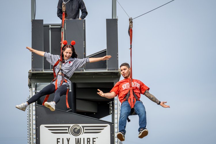 Two people on a zip line