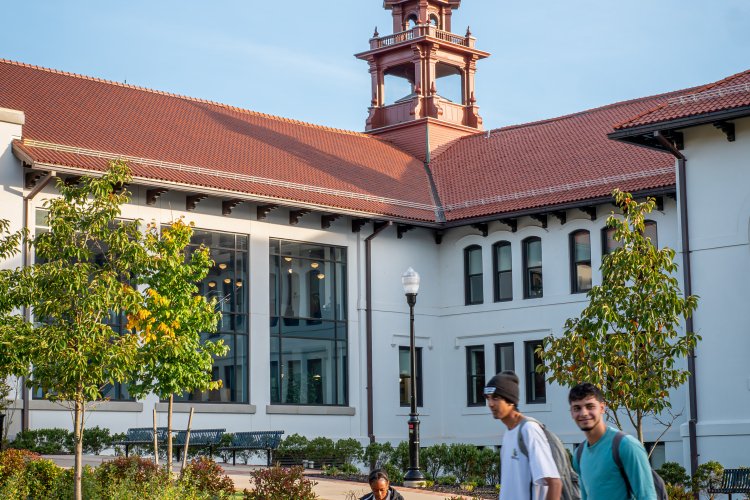 Two students walking in front of a building on Montclair's campus.
