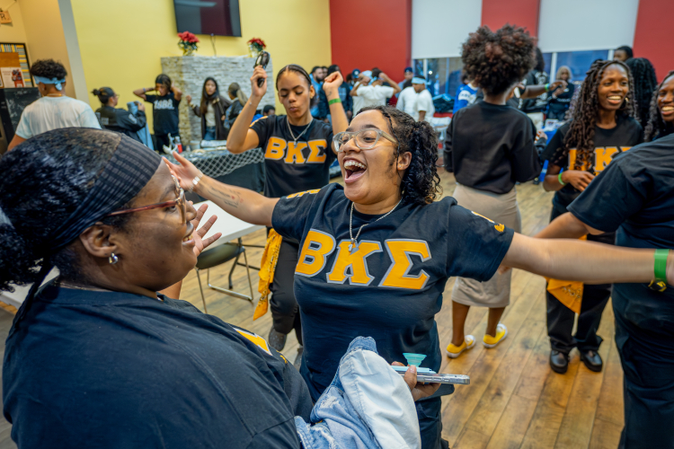 Student with arms open for hug