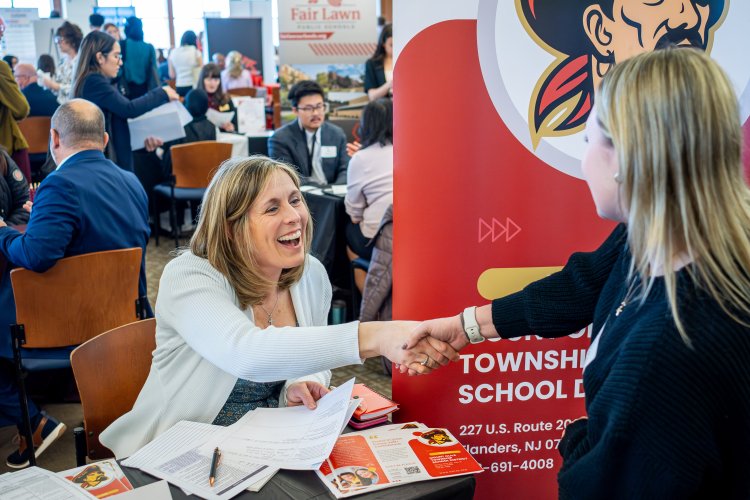 students shakes hands with interviewer