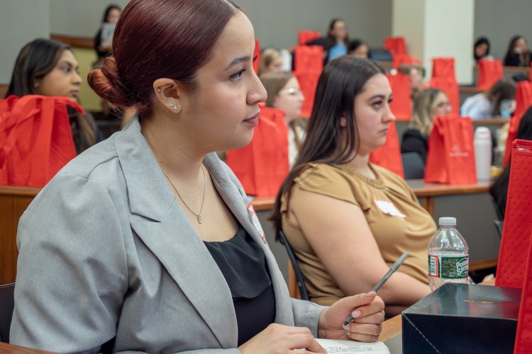students listen as a speaker talks in a classroom