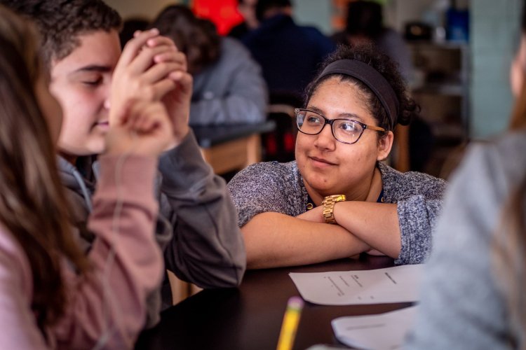 Teacher helps student at table