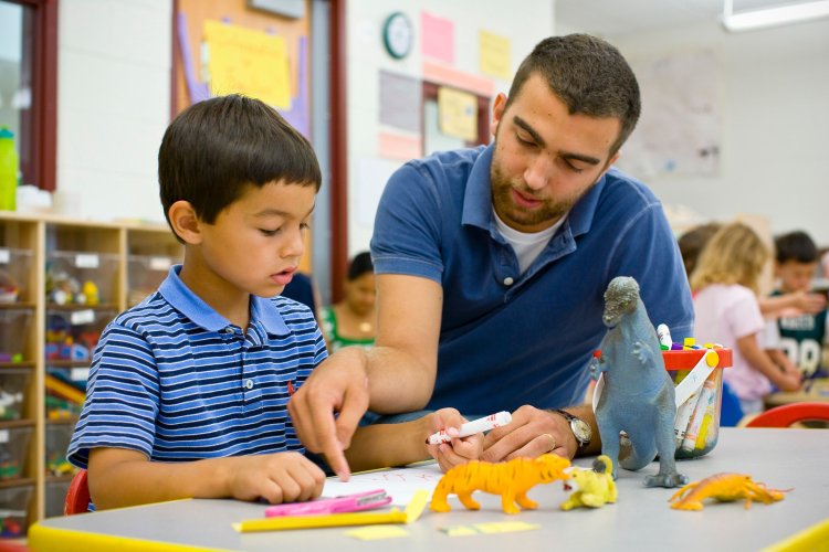teacher shows student how to do work