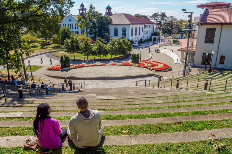 Amphitheater with two people sitting for scout location on campus