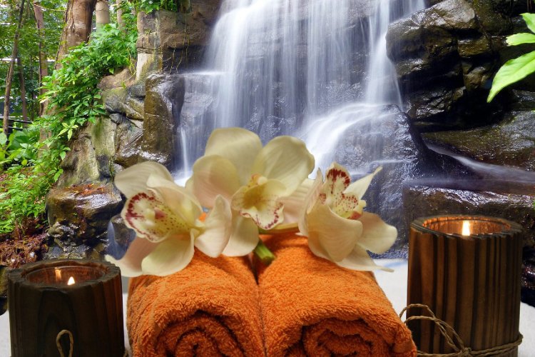 Spa towels with a waterfall backdrop