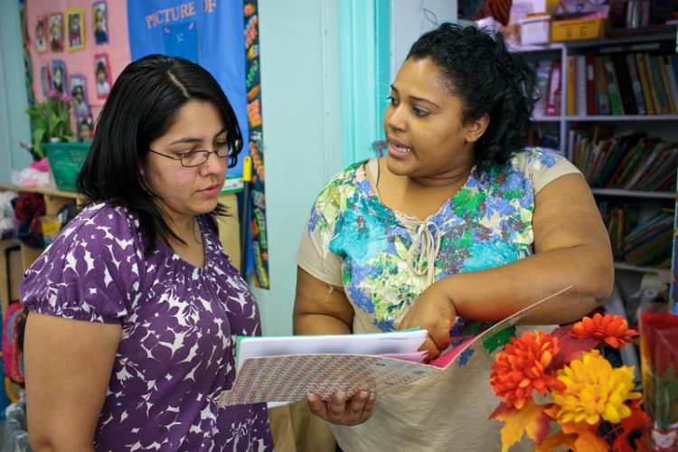 two teachers chat in a clasroom