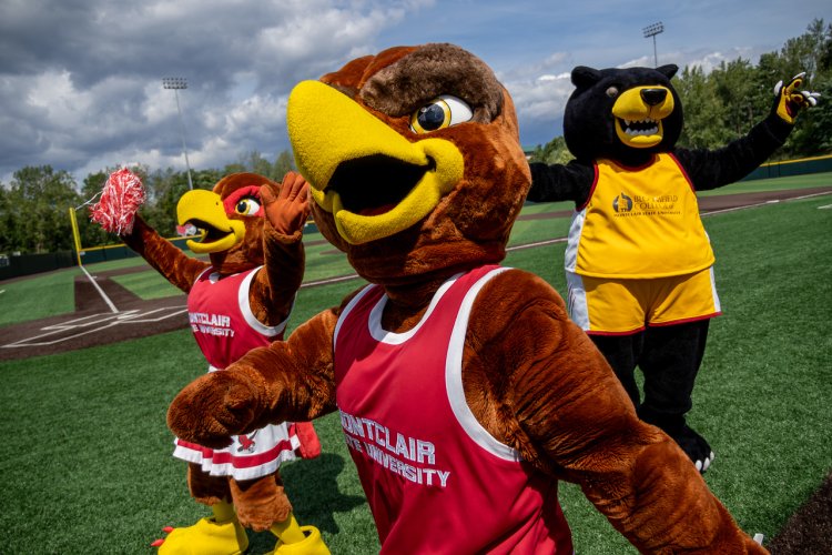 Rocky the Red Hawk mascot with Roxy the Red Hawk and Deacon the Bloomfield Bear mascots 