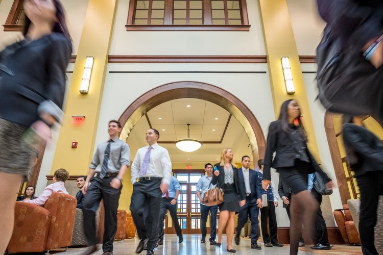 Students walking in School of Business building atrium