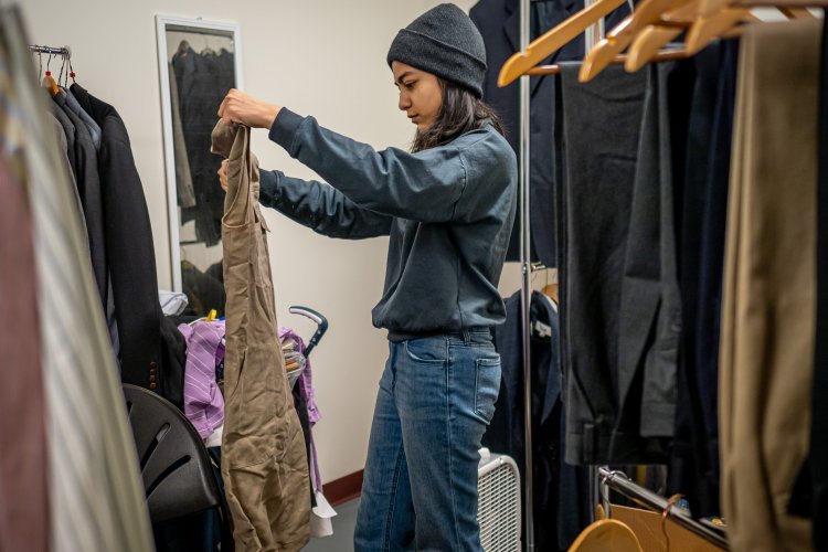 student worker at rockys closet sorting clothes