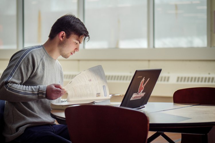 a student studies at his laptop