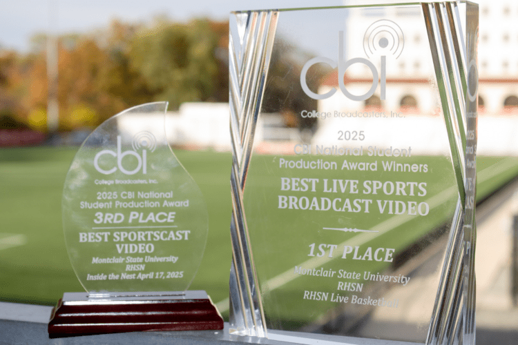 Two awards standing side by side, the one on the left says 2025 CBI National Student Production Award 3rd place for Best Sportscast Video awarded to Montclair State University RHSn for Inside the Nest April 17,2025, and second award says 2025 CBI National Student Production Award Winners for Best Live Sports Broadcast Video 1st place for Montclair State University RHSN for RHSN Live Basketball.