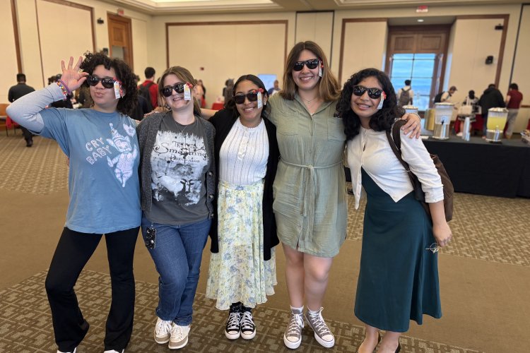 Teacher Ed students pose with branded sunglasses at orientation