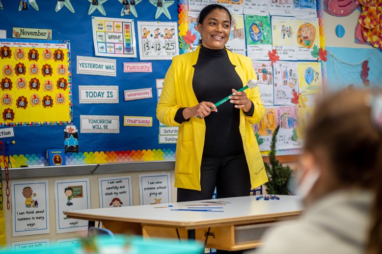 Teacher stands in front of class