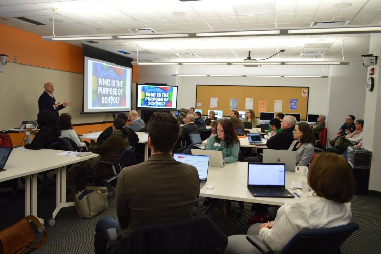 Faculty and staff attending a presentation at the AI Showcase