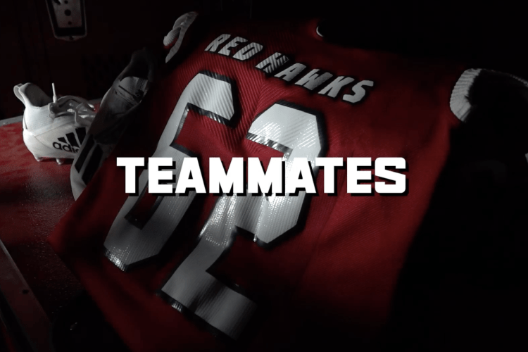 Screenshot of Teammates documentary graphic. Teammates sits in the middle in white font and behind the text is a jersey that says Red Hawks 62.