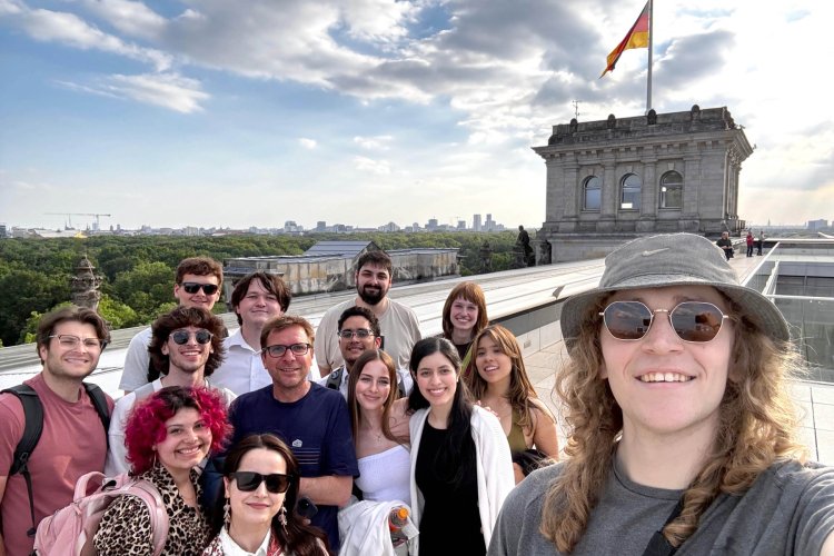 A group of college students posing for a selfie atop a German building