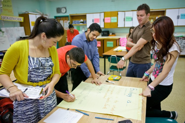 a group of students work at a desk together
