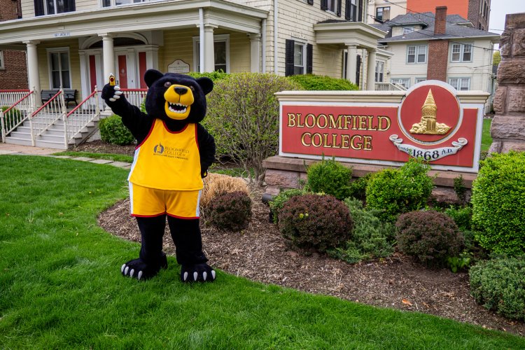 Deacon the Bloomfield Bear Mascot waving 