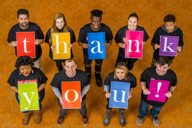 students holding letters that spell thank you