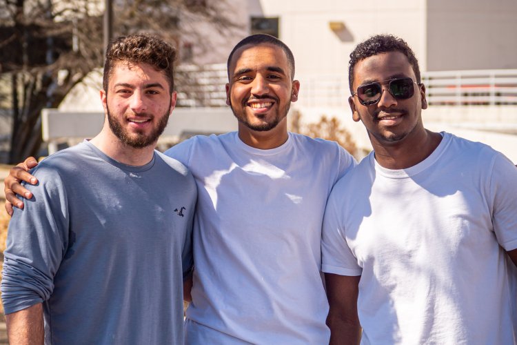 three students smiling