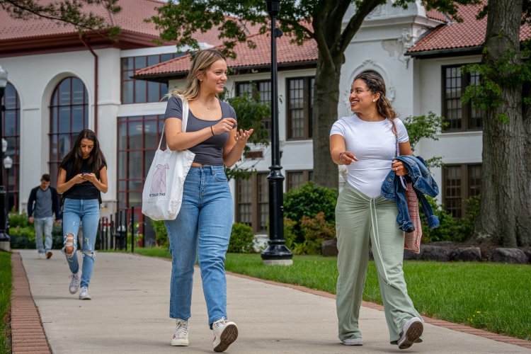A picture of two students walking on campus