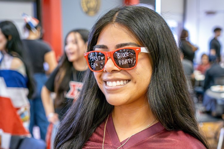 student wearing sunglasses smiling