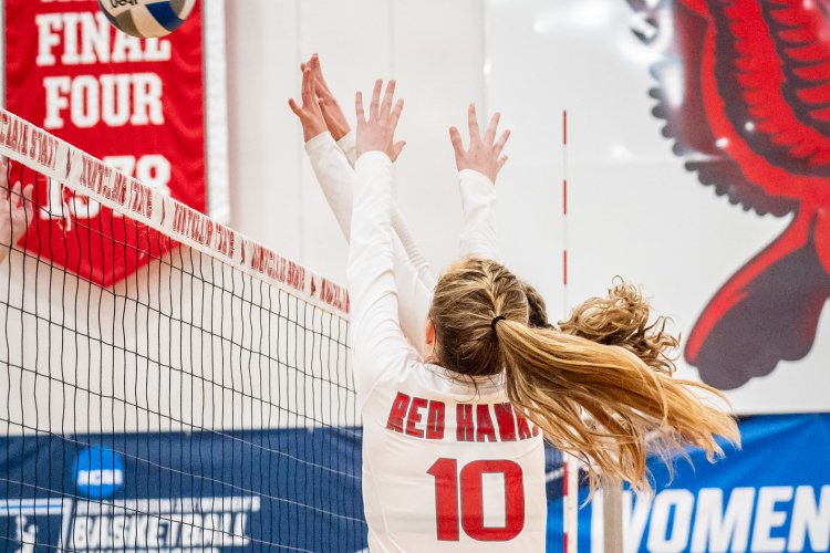 student playing volleyball