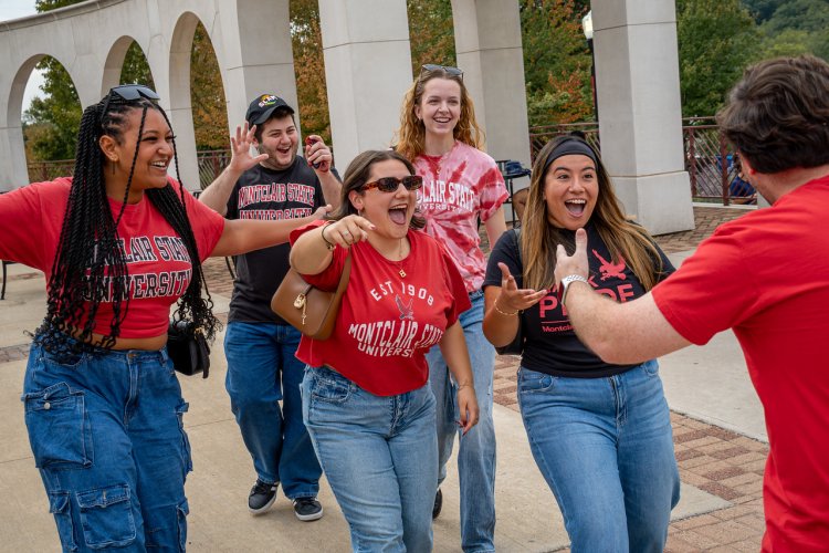 A group of people excited to greet another person