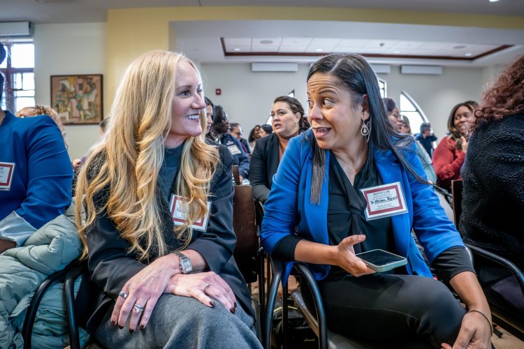two employees engaging in conversation