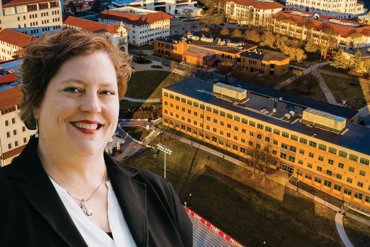 Amy Thompson posing with a photoshopped building behind her.