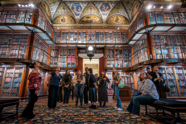 A group of college students stand in the middle of the Morgan Library in New York City