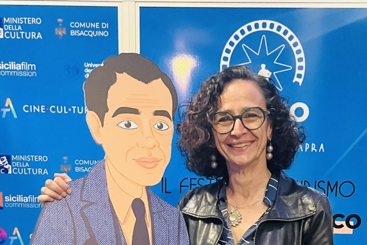 Dr. Teresa Fiore poses with a cartoon-styled cardboard cut-out of film director Frank Capra