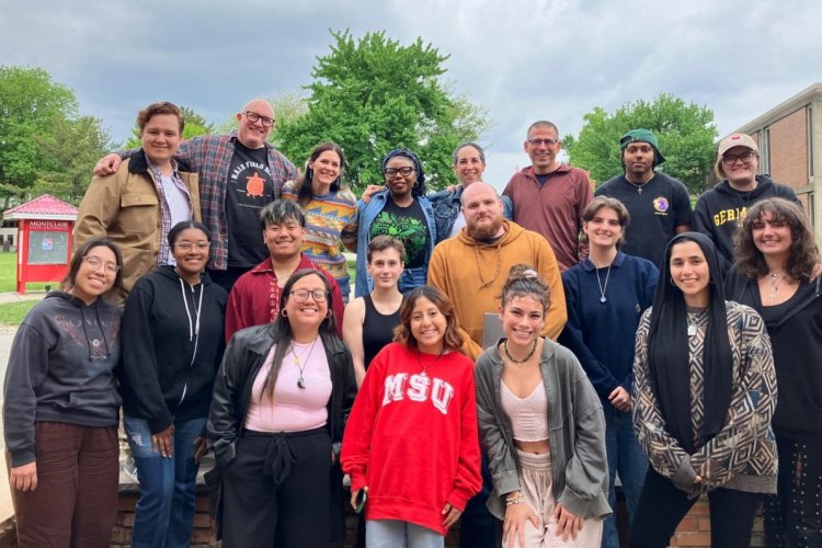 a group of people pose together on the campus of Montclair State University