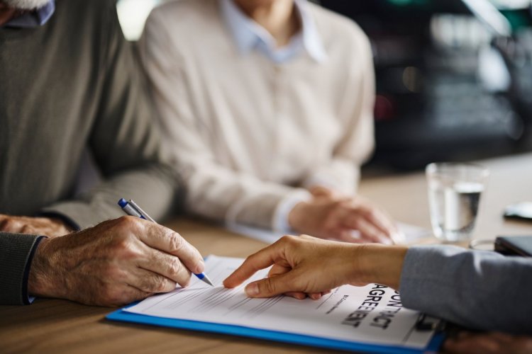 Image of perrson signing an agreement
