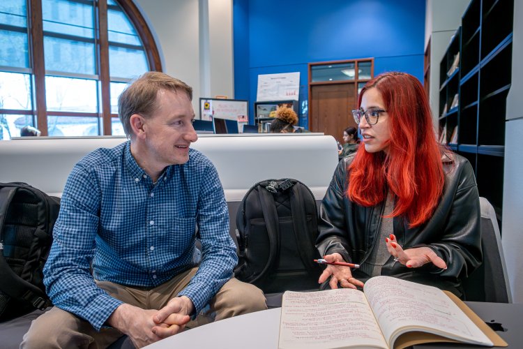 Counseling student discussing her research with a faculty member. 
