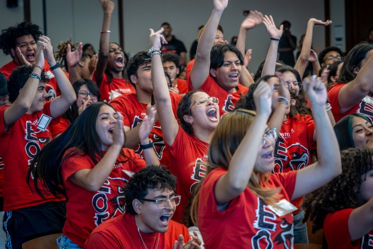 student cheering at a conference