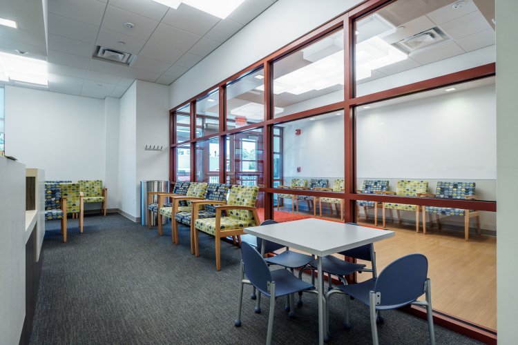 Waiting room for Center for Clinical Studies. There are rows of chairs and a small desk for children.