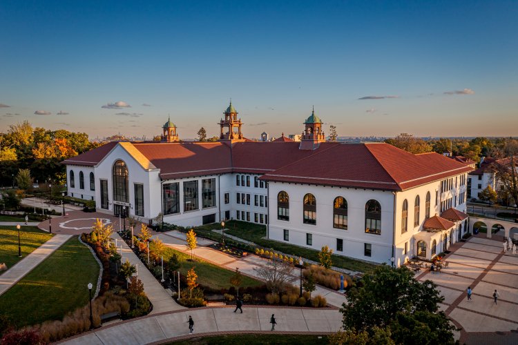 Aerial photo of Cole Hall and students walking.