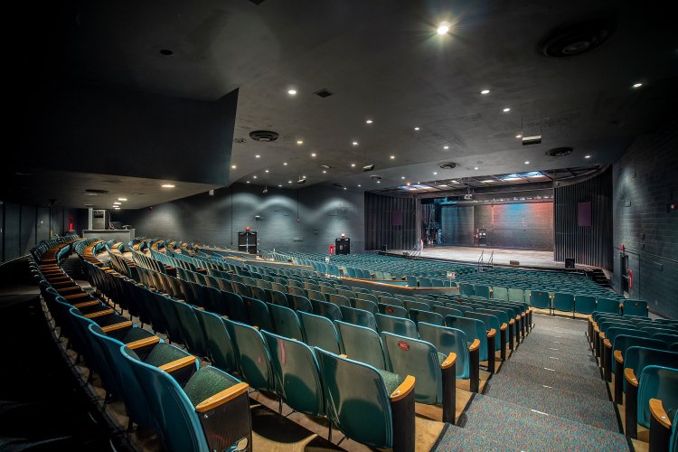 Interior look of the Memorial Auditorium. The seats are empty and facing the stage.
